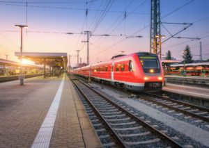 Passenger high speed train on the railway station at sunset